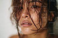 Close-up of Woman with Wet Hair and Glowing Skin for Beauty and Fashion