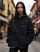 Fashionable Woman Wearing Black Hoodie in Urban City Street