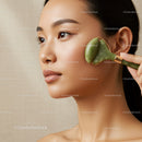 Elegant Asian Woman Performing Facial Massage with Jade Roller