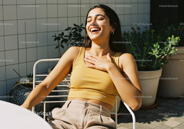 Joyful Woman Laughing Outdoors in Sunny Terrace Scene