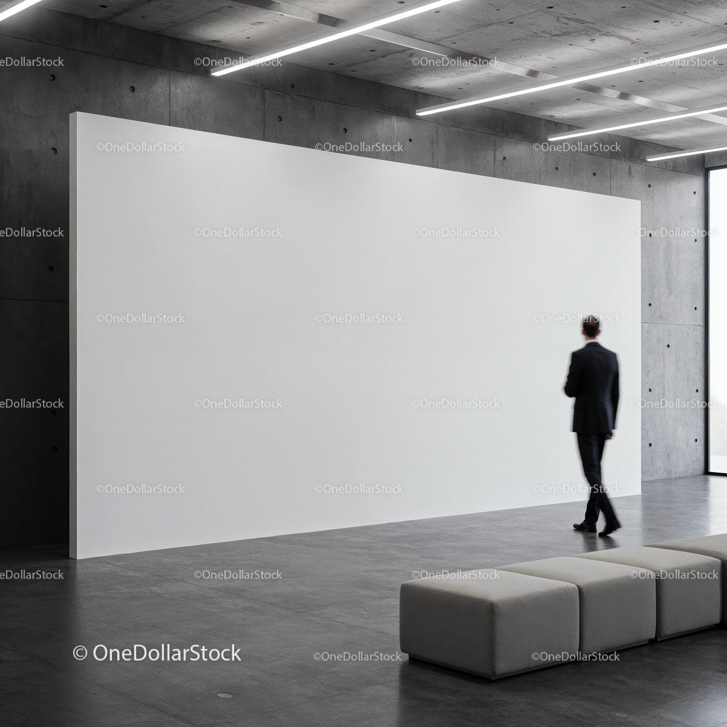 Man walking past large blank white gallery wall