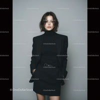 Stylish Woman in Black Blazer and Skirt in a Minimalist Photo Setup