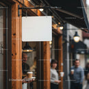 Blank hanging sign outside urban coffee shop entrance