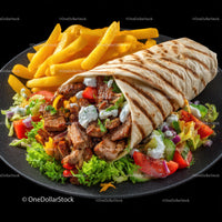 Grilled Chicken and Vegetable Wrap with Salad and Fries on Black Plate