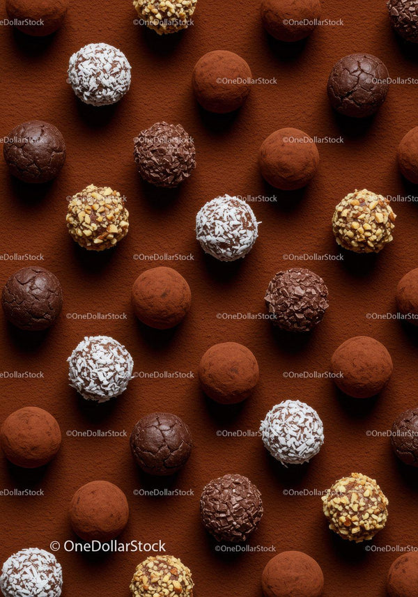 Assortment of gourmet chocolate truffles on cocoa powder