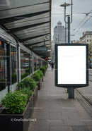 Urban tram stop with modern greenery and blank billboard