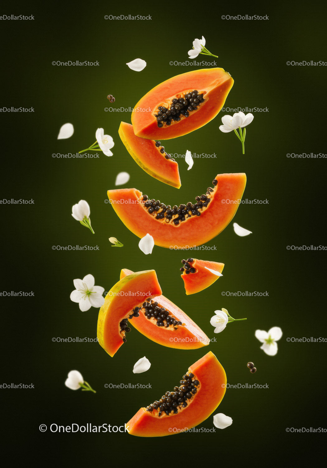 Fresh papaya slices with white flowers floating on green