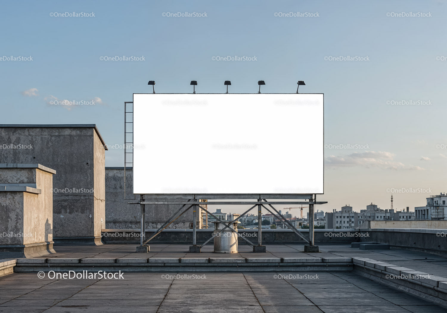 Blank billboard on urban rooftop under clear sky
