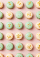 Pastel Macarons with Gold Sprinkles on Pink Background