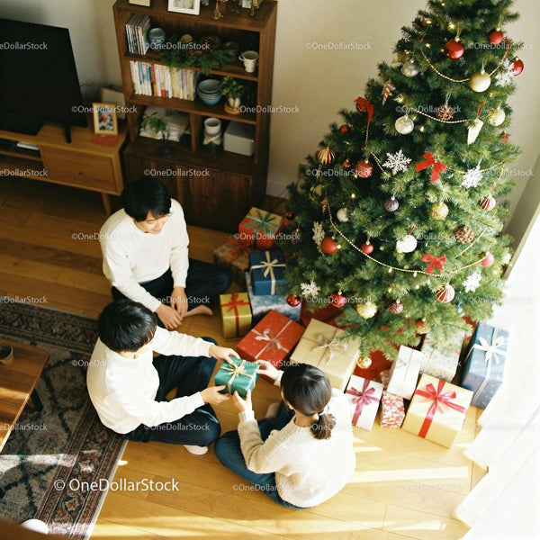 Family exchanging gifts by the decorated Christmas tree
