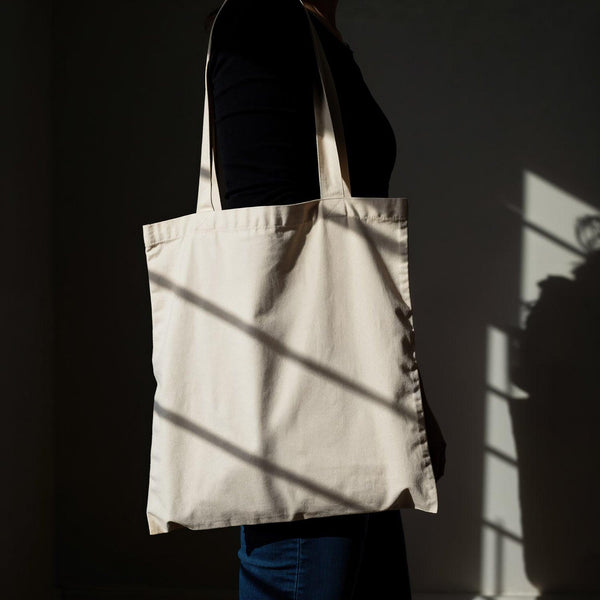 Person Carrying Plain Canvas Tote Bag in Natural Light JPG Mockup Image