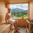 Man Relaxing in a Sauna with Mountain View and Wooden Interior