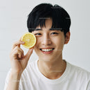 Happy Young Man Holding Lemon Slice with Bright Smile and Fresh Vibe