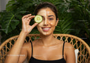 Woman with Facial Mask and Cucumber in Wellness Spa Setting