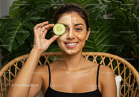 Woman with Facial Mask and Cucumber in Wellness Spa Setting
