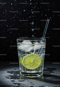 Refreshing glass of sparkling water with lime and ice