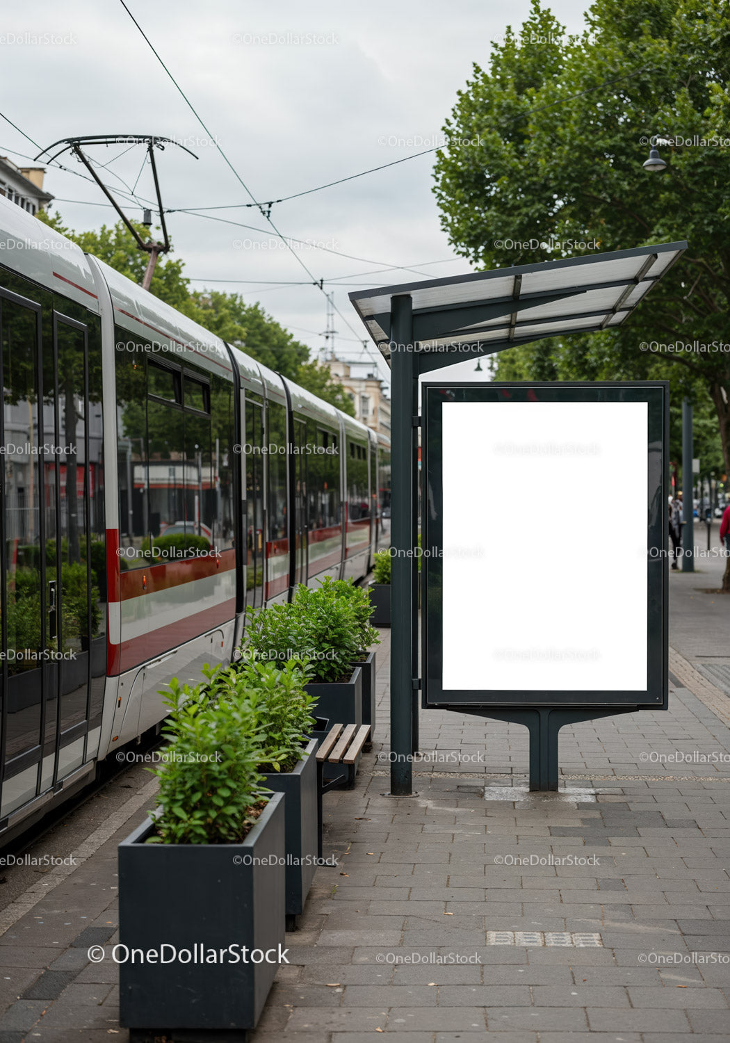 Modern tram station with green plants and empty billboard