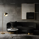 Modern living room with black sofa and gold accents