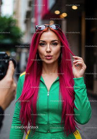Vibrant Red Hair Woman in Green Tracksuit with Sunglasses in City