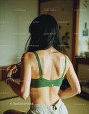 Woman in Green Sports Bra Doing Indoor Workout or Yoga
