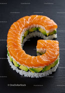 Fresh salmon sushi roll shaped as letter G on black plate