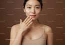 Young Woman with Creams on Cheeks in Skincare Routine