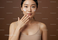 Young Woman with Creams on Cheeks in Skincare Routine