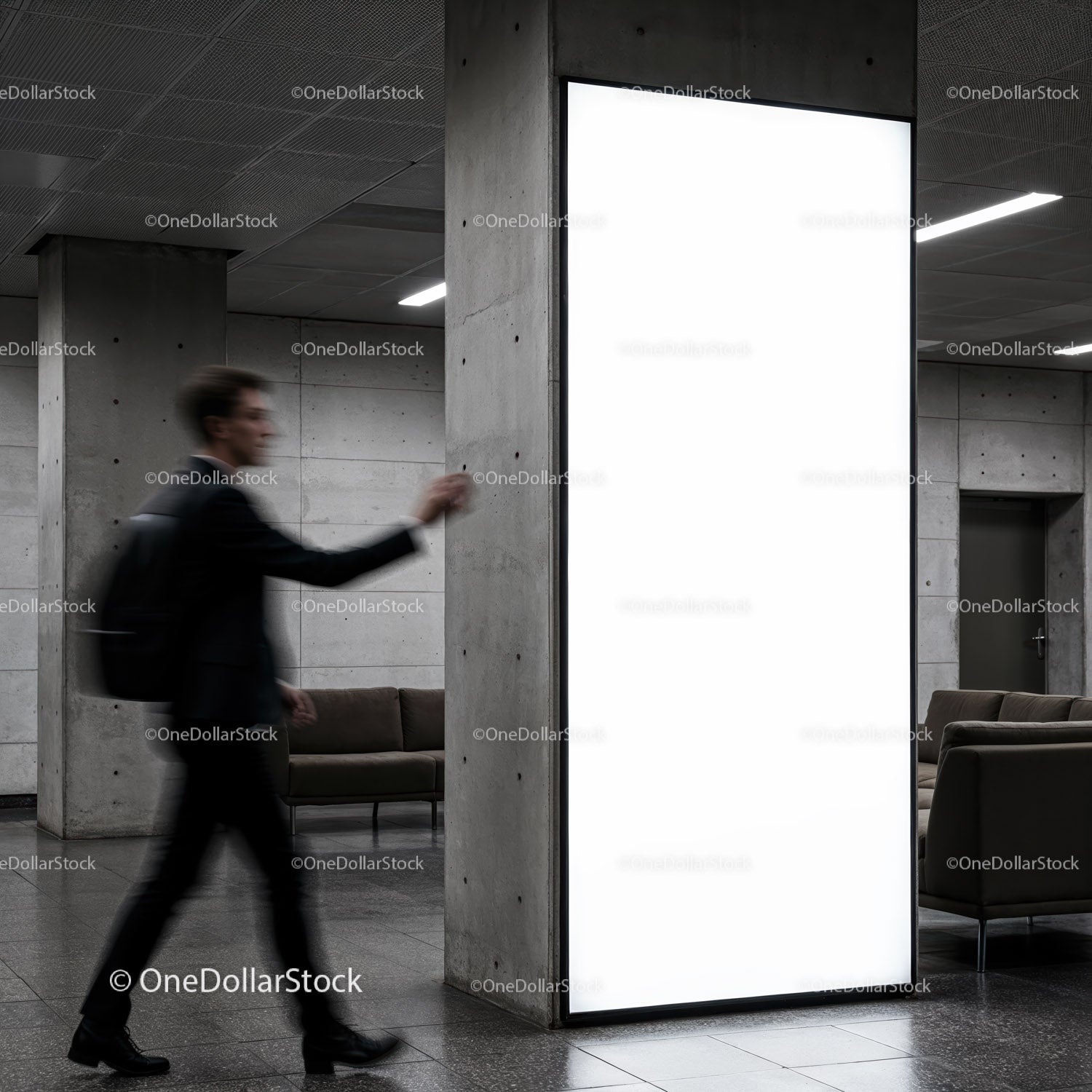 Blurred man walking past illuminated urban advertisement panel