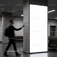Blurred man walking past illuminated urban advertisement panel