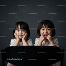 Two Happy Girls with Joyful Expressions Sitting Together