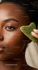 Elegant Black Woman with Glowing Skin Holding Green Jade Heart