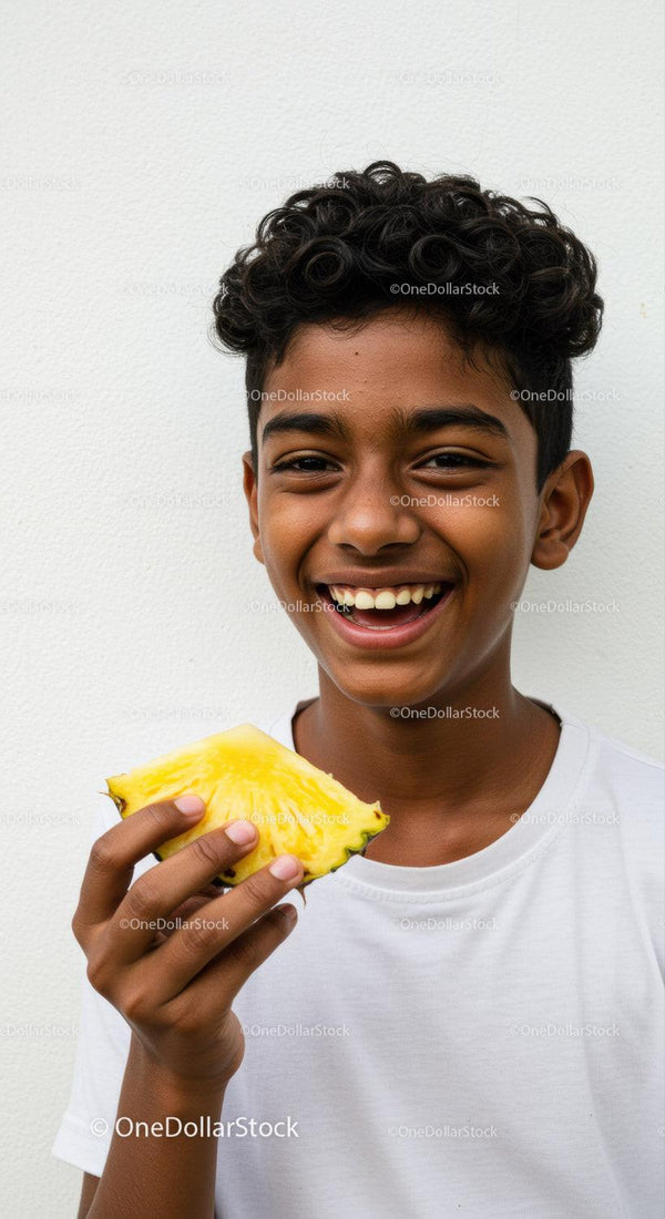 Young Boy Smiling with Fresh Pineapple Over White Background