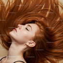 Calm woman with flowing red hair lying down peacefully