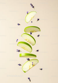 Sliced green apple with scattered lavender buds