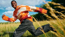 Smiling young man running through a sunny meadow
