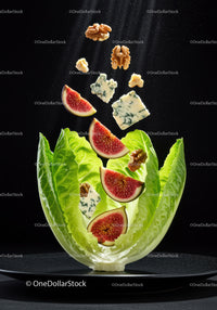 Fresh fig slices with blue cheese and walnuts on lettuce