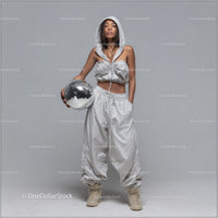 Stylish Woman in Metallic Outfit Holding Disco Ball for Modern Fashion