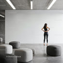 Woman in activewear stretching in modern minimalist room