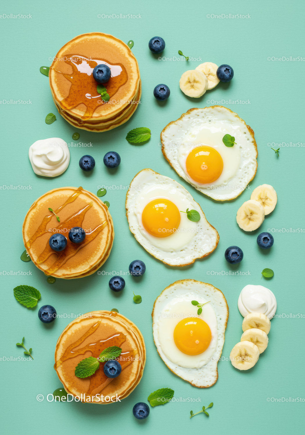 Delicious breakfast with pancakes fried eggs and fruit