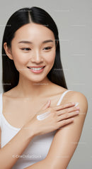 Young Woman Applying Cream for Healthy Glowing Skin