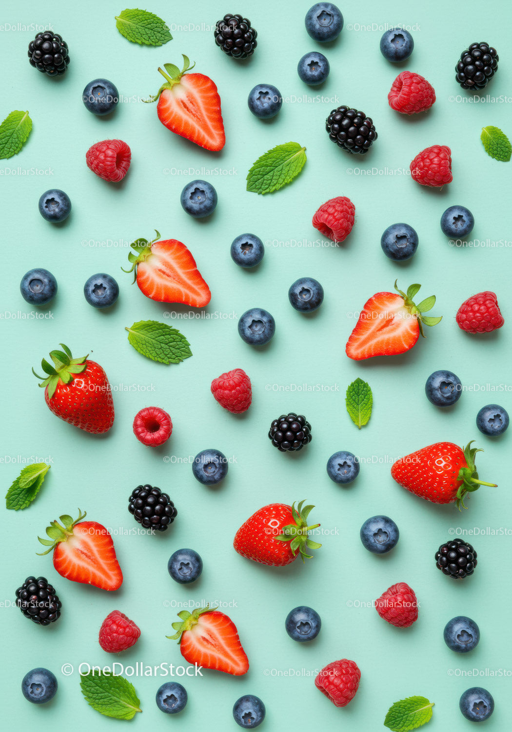 Fresh mixed berries and mint leaves on pastel background