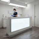 Medical professional organizing documents in clinic reception