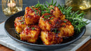 Crispy Chicken Bites with Spicy Sweet Glaze Garnished with Herbs