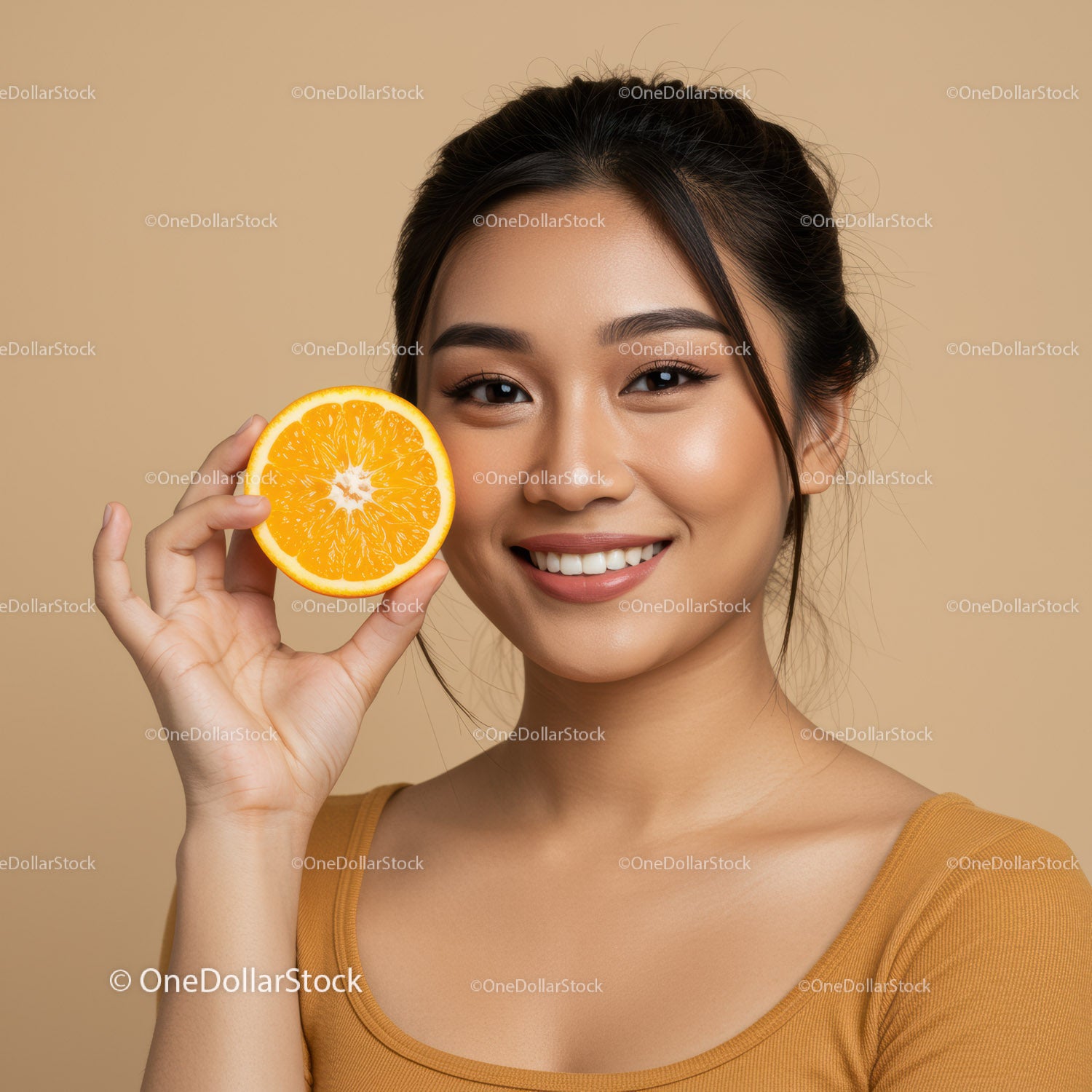 Portrait of a Smiling Woman with Orange Slice and Bright Facial Skin