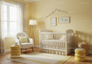 Bright Nursery with White Baby Crib and Yellow Accents