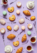 Assorted French pastries with tea and lavender on purple