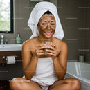 Young Woman Relaxing with Facial Mask in Cozy Bathroom