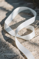 Close-up of White Plastic Ribbon Waste on Sandy Beach