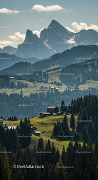 Majestic Snow-Capped Mountain Range with Green Forest and Rustic Cabins