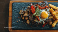 Juicy Beef Steak with Fried Egg and Crispy French Fries